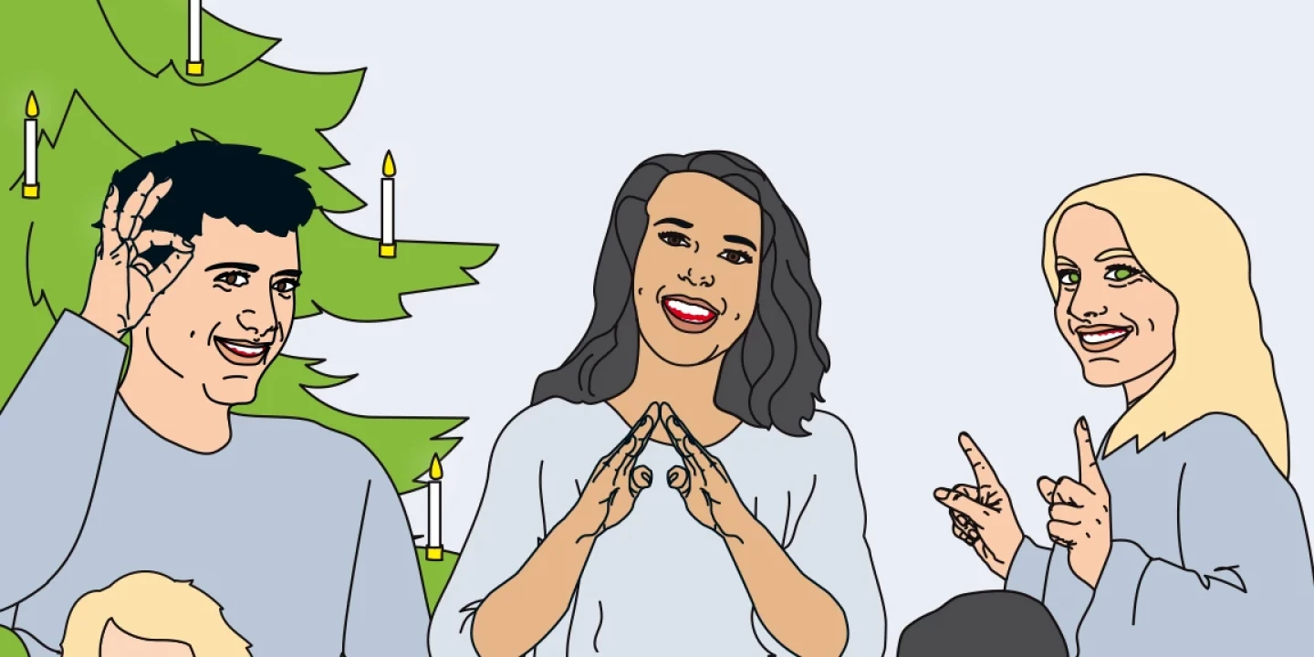 F&uuml;nf Personen in entspannter Atmosph&auml;re neben einem Weihnachtsbaum mit Kerzen. Zwei Erwachsene zeigen Geb&auml;rden, eine Frau in der Mitte bildet mit den Fingern ein "Herz". Ein Kind isst Kekse an einem Tisch mit einem Teller voller Kekse. Daneben eine dekorative Santa-Figur und ein Monitor.
